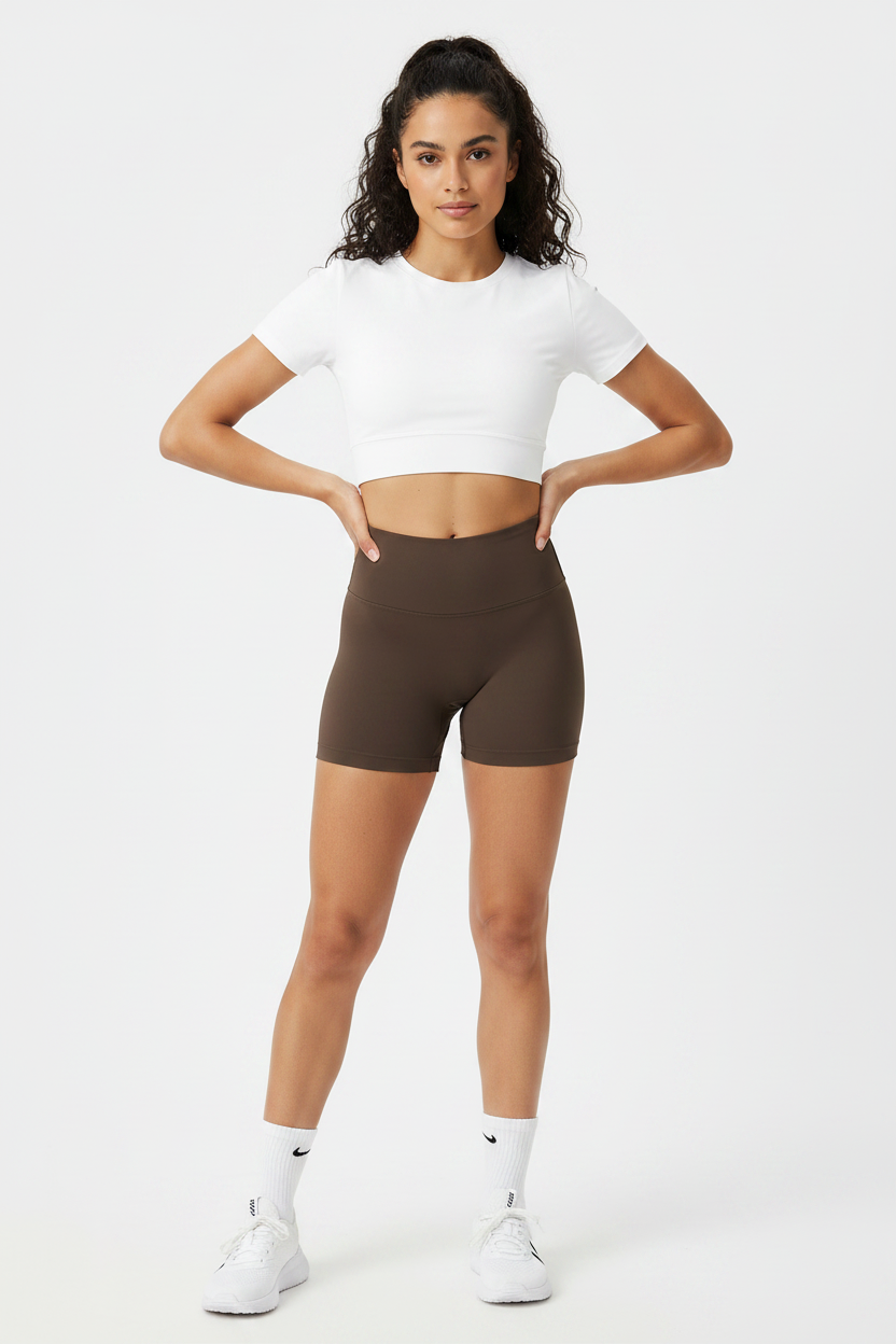 Model wearing dark brown high-waist sports shorts