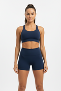 Model wearing navy blue high-waist sports shorts