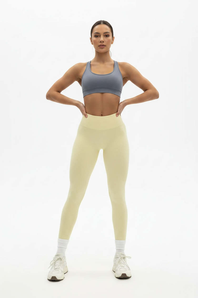 Woman wearing butter yellow PowerForm Legging, front pose