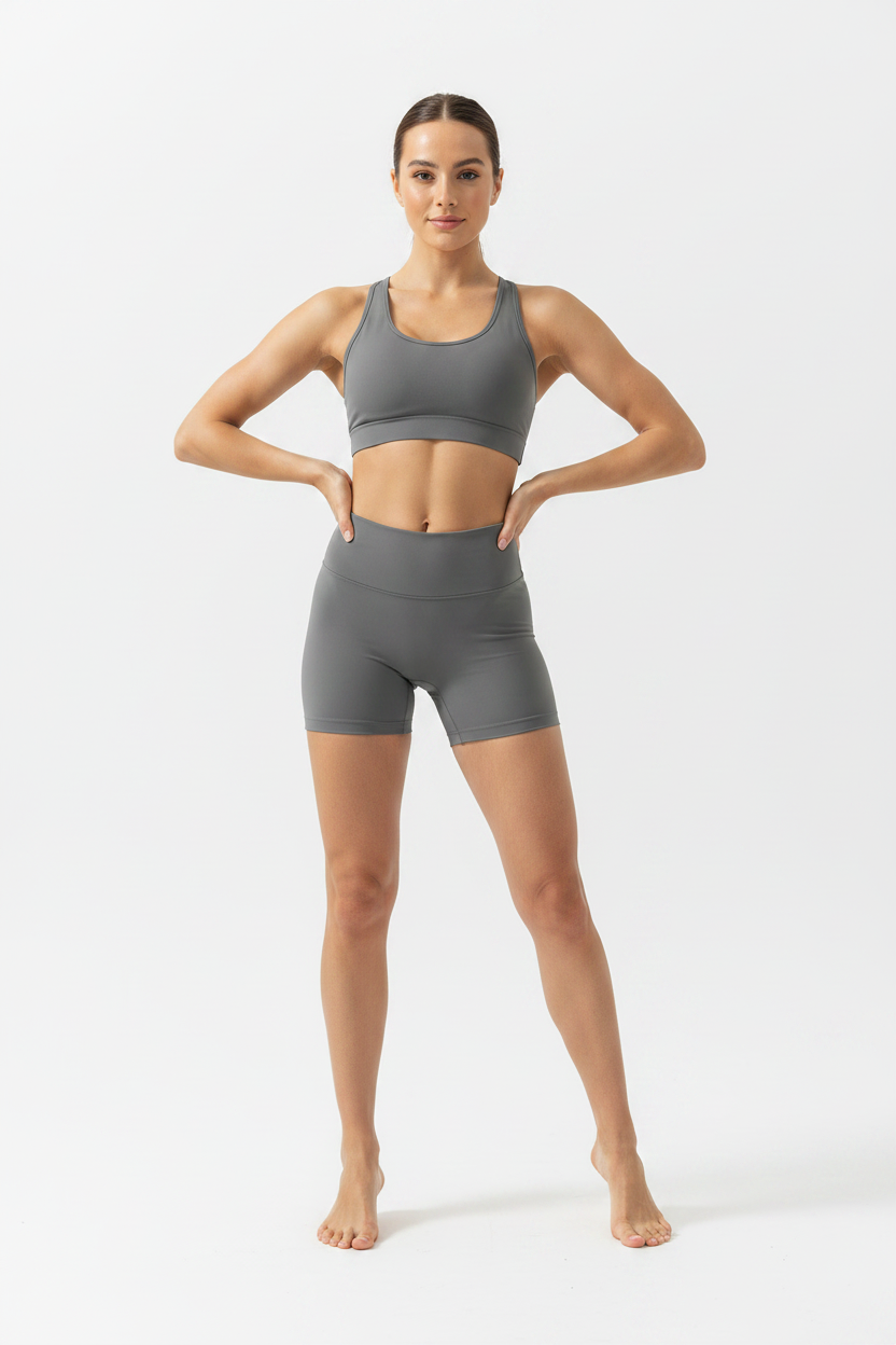 Model wearing graphite gray high-waist sports shorts