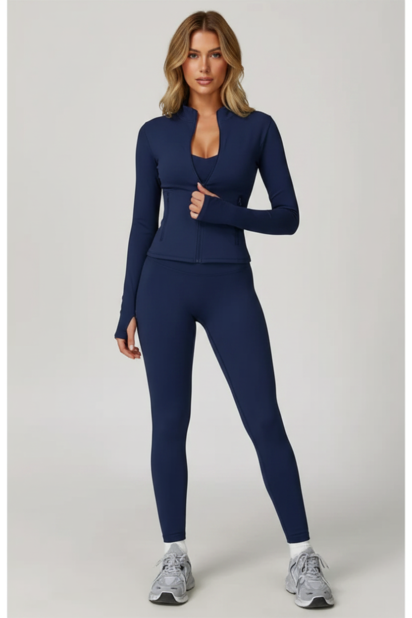 Model wearing badge blue tracksuit holding zipper with full face visible